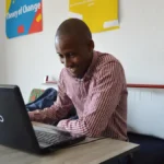 Graphic designer working on a laptop, representing creative AI workflow tools