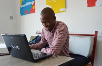 Graphic designer working on a laptop, representing creative AI workflow tools