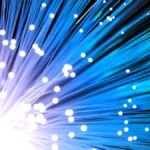 Blue-lit fiber optic cable representing high-speed data center networking
