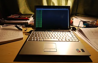 A laptop running terminal output on a desk, illustrating sandboxed Ubuntu developer tooling.