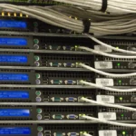 Rear view of server racks with network cabling, representing etcd cluster membership and data-plane operations
