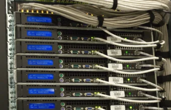 Rear view of server racks with network cabling, representing etcd cluster membership and data-plane operations