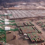 Aerial view of shipping containers and cranes, used as a visual metaphor for open source supply-chain coordination
