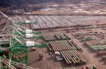 Aerial view of shipping containers and cranes, used as a visual metaphor for open source supply-chain coordination