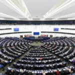 European Parliament hemicycle during a plenary session representing AI regulation and compliance governance