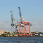 Container terminal cranes and shipping containers representing software supply-chain visibility and SBOM release gates