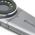 A handheld dermatoscope on a white background representing skin examination technology
