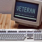 Vintage VT420 terminal and keyboard showing a Linux login screen