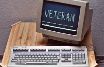 Vintage VT420 terminal and keyboard showing a Linux login screen