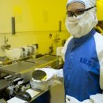 Researcher holding a silicon wafer, representing AI inference accelerator infrastructure