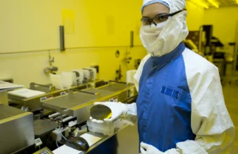Researcher holding a silicon wafer, representing AI inference accelerator infrastructure