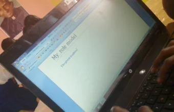 Students learning to type on laptop computers, representing structured AI and LLM training for engineering teams