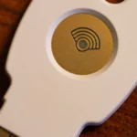 A physical security key on a laptop keyboard, representing governed API key access for enterprise AI