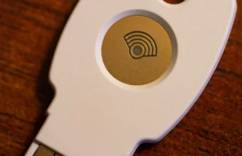 A physical security key on a laptop keyboard, representing governed API key access for enterprise AI