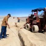 Workers laying a fiber data cable, used as a visual metaphor for CDN supply-chain risk