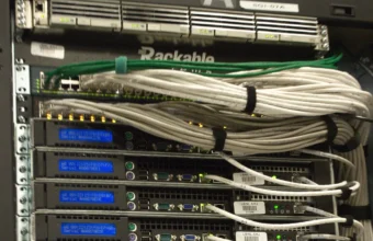 Rear of a data center rack with network cables and server hardware