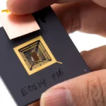 A researcher holds an early RISC-V prototype chip, representing RISC-V hardware development