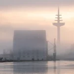 Telecommunications tower at sunrise, representing telco network infrastructure for AI operations