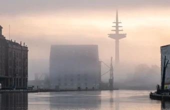 Telecommunications tower at sunrise, representing telco network infrastructure for AI operations