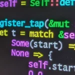 Rust source code on a laptop screen representing AI coding-agent development risk