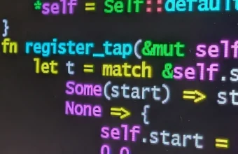 Rust source code on a laptop screen representing AI coding-agent development risk