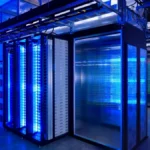 Blue-lit server racks in a modern data center, illustrating the compute infrastructure behind the AI boom.