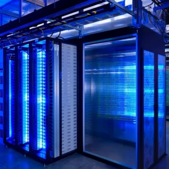 Blue-lit server racks in a modern data center, illustrating the compute infrastructure behind the AI boom.