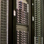 Rows of server racks in a data center, illustrating the infrastructure behind frontier AI funding.
