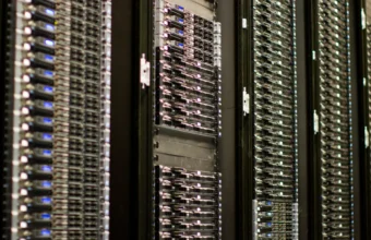 Rows of server racks in a data center, illustrating the infrastructure behind frontier AI funding.