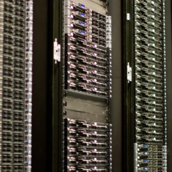 Rows of server racks in a data center, illustrating the infrastructure behind frontier AI funding.