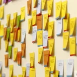 Colorful sticky notes arranged on an office wall, symbolizing governance checklists and planning.