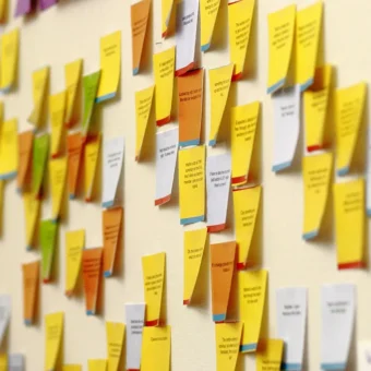 Colorful sticky notes arranged on an office wall, symbolizing governance checklists and planning.