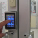 A keypad access-control reader beside a secure laboratory entrance