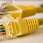 Close-up of yellow Ethernet connectors representing a secure network connection