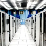 A bright server room aisle with cabinet rows, representing web-server infrastructure and TLS security operations.