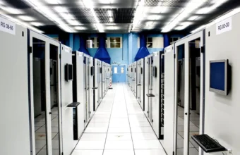 A bright server room aisle with cabinet rows, representing web-server infrastructure and TLS security operations.