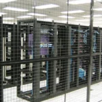 Rows of caged data-center racks, representing edge infrastructure protected by web application firewall and threat-intelligence rules.
