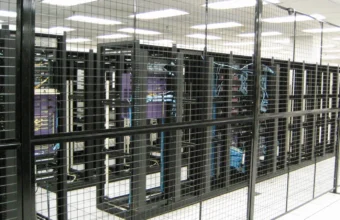 Rows of caged data-center racks, representing edge infrastructure protected by web application firewall and threat-intelligence rules.