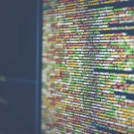Close-up of source code on a computer monitor, representing a self-hosted Git server vulnerability.