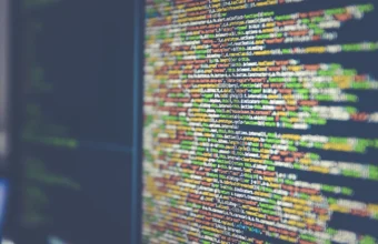 Close-up of source code on a computer monitor, representing a self-hosted Git server vulnerability.