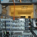 Rear view of rack-mounted servers and cables for KubeVirt benchmarking article