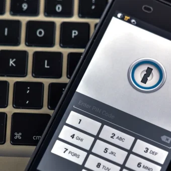 A phone security app on a smartphone resting on a laptop keyboard.