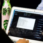 A laptop showing a code editor and terminal during a programming session, representing Python release testing.