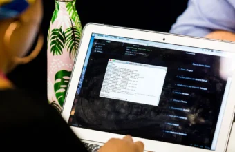 A laptop showing a code editor and terminal during a programming session, representing Python release testing.