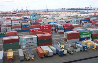 Rows of shipping containers at a port terminal, used as a physical metaphor for software supply chain security controls.