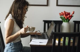 A woman working on a laptop in a home office, representing resilient software startup operations