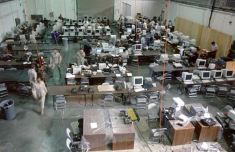 Operations center staff working at rows of computer workstations