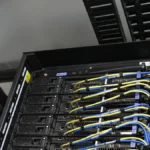 Power and network cable rails in a modular data center rack representing private Droplet bastion access and cloud firewall boundaries
