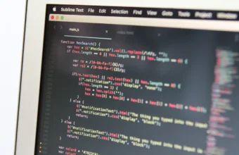 Close-up of syntax-highlighted code on a laptop screen, representing the Kubernetes tooling development behind the new Headlamp Kubeflow plugin