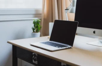 Laptop and desktop computer on a clean desk, representing a local AI development setup